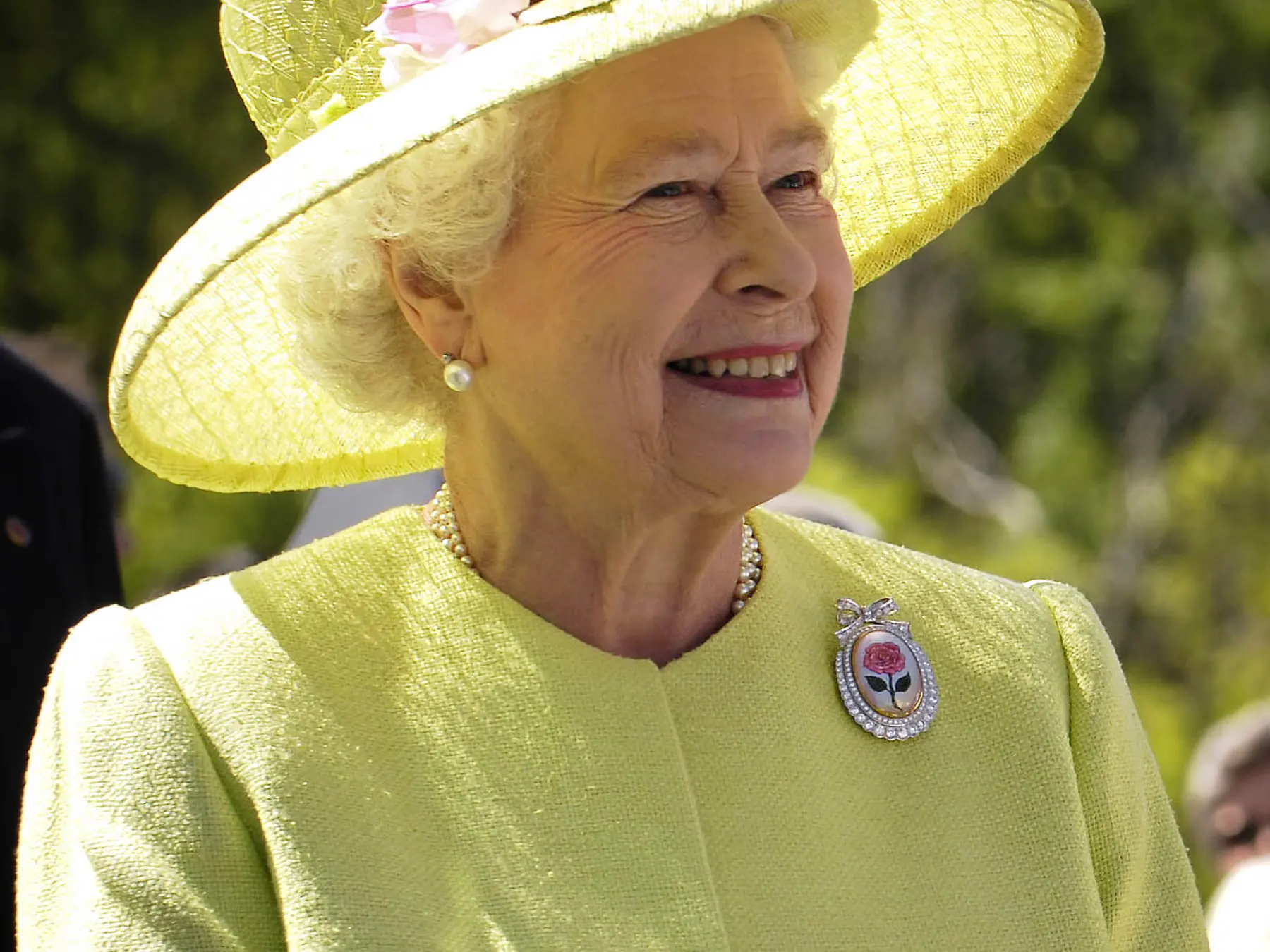Queen Elizabeth II smiling during a visit with NASA employees in 2007