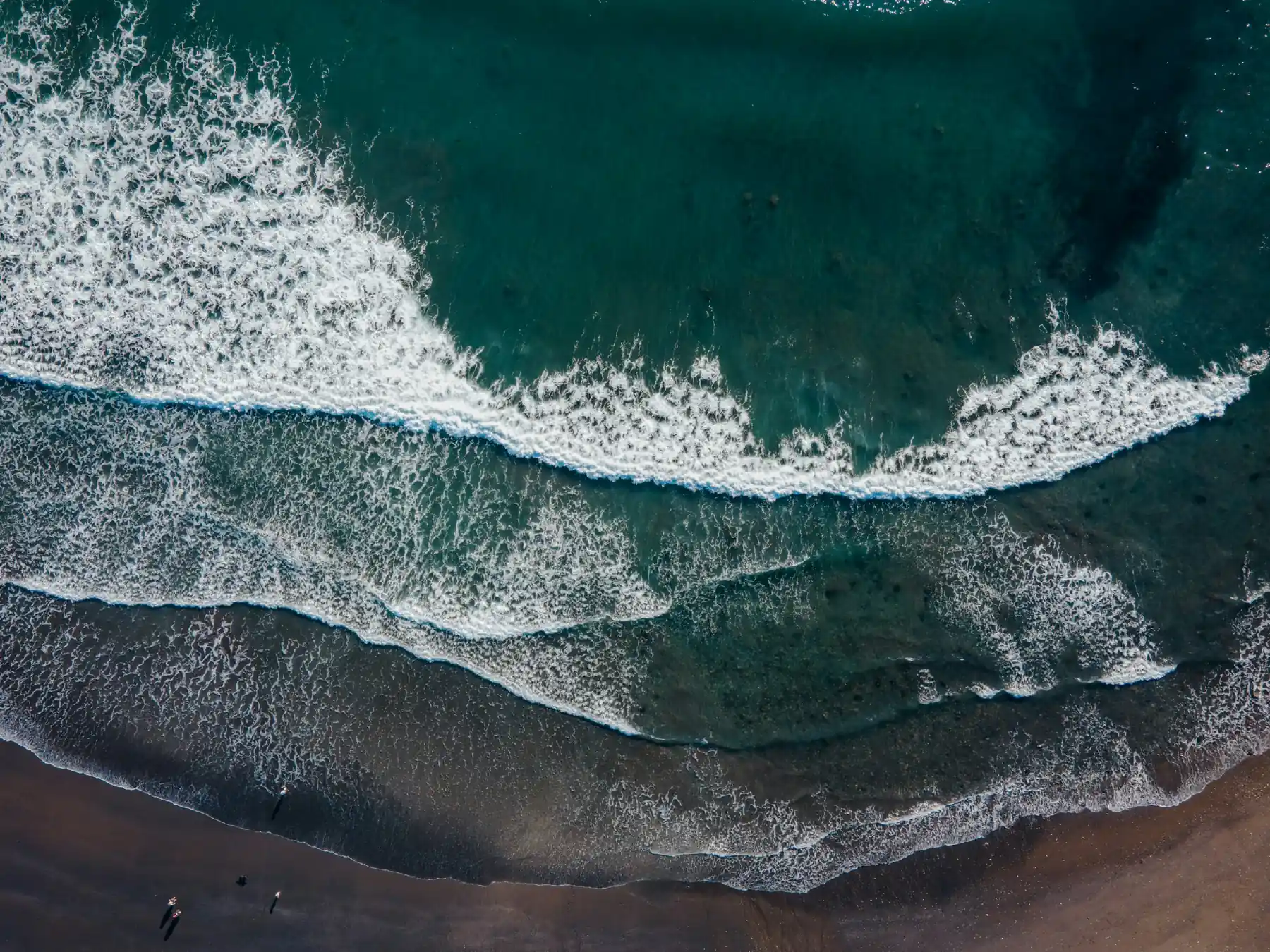 Aerial view of waves rolling onto the Pembrokeshire coast in Wales