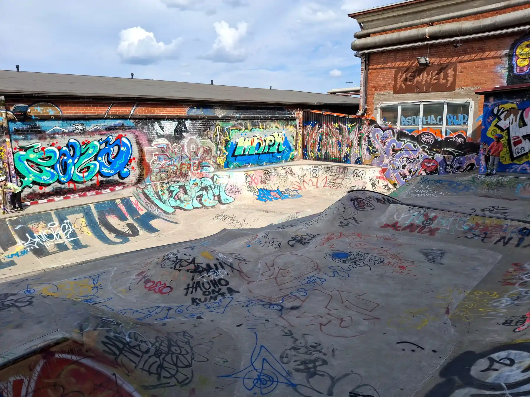 Concrete skate bowl covered with colorful graffiti