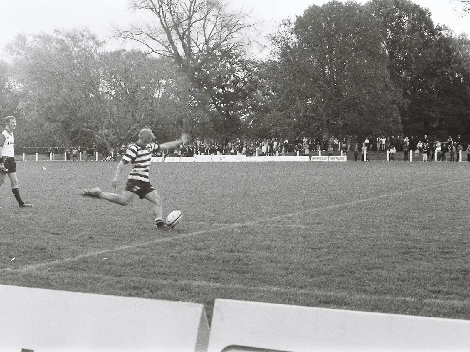Rugby player kicking during a historic match