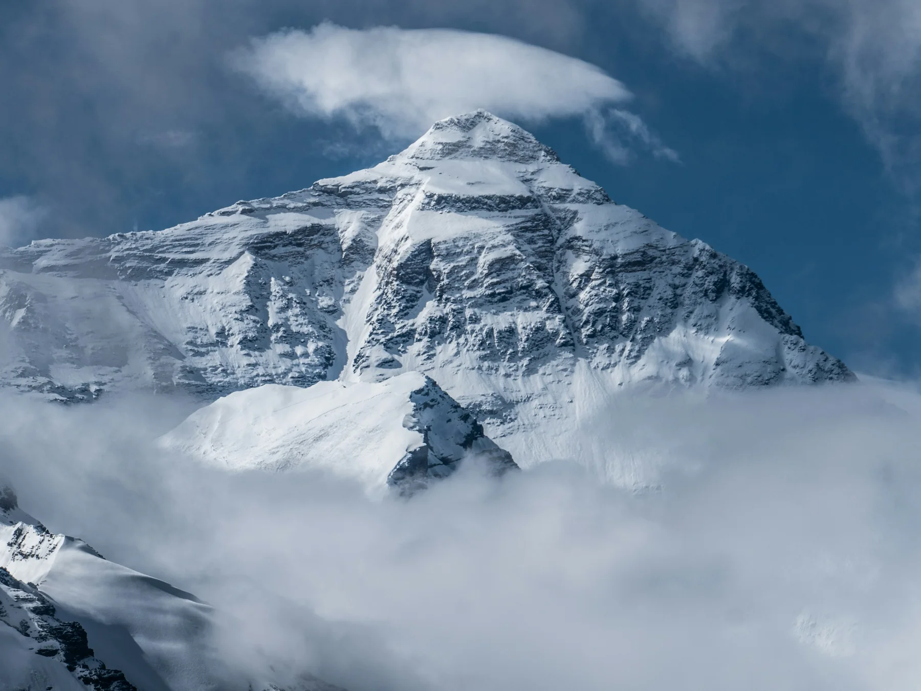 Mount Everest rising above a blanket of clouds