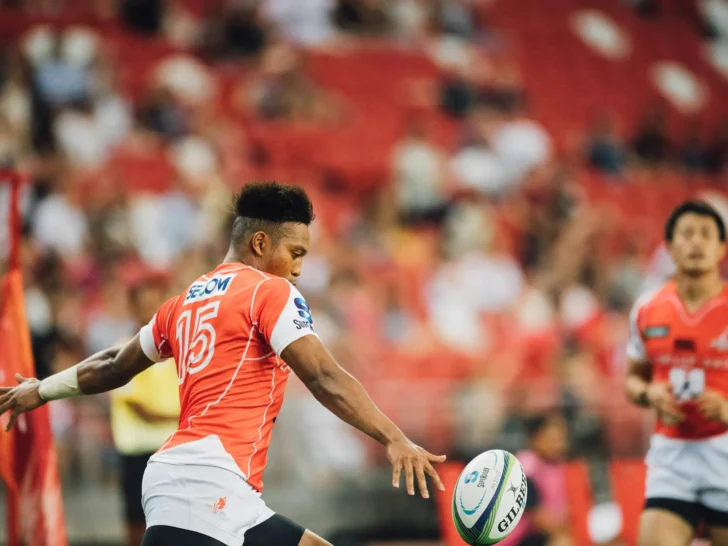 Rugby player kicking the ball during a match
