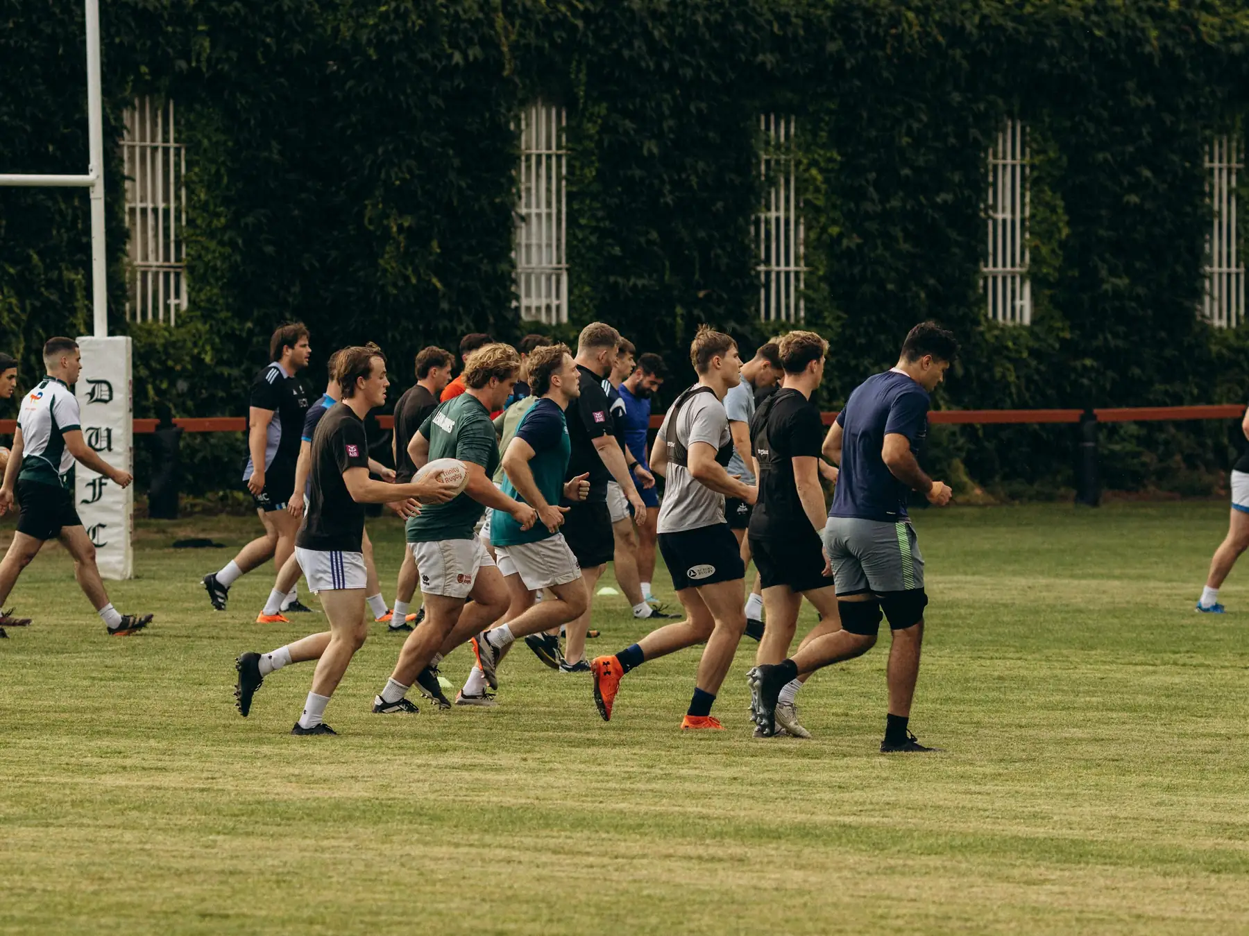 Rugby players running together during training