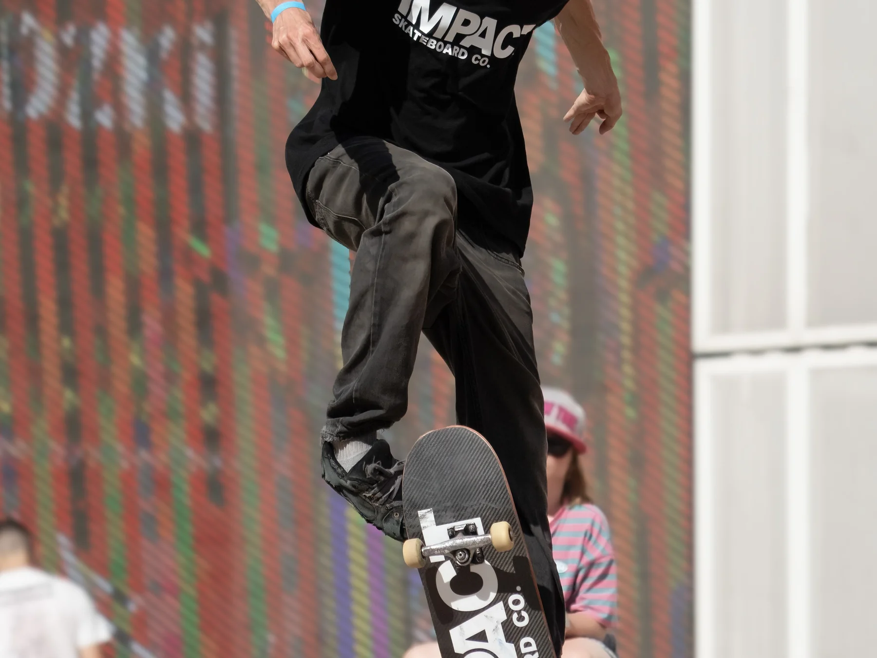 Skateboarder balancing on the raised nose of a board