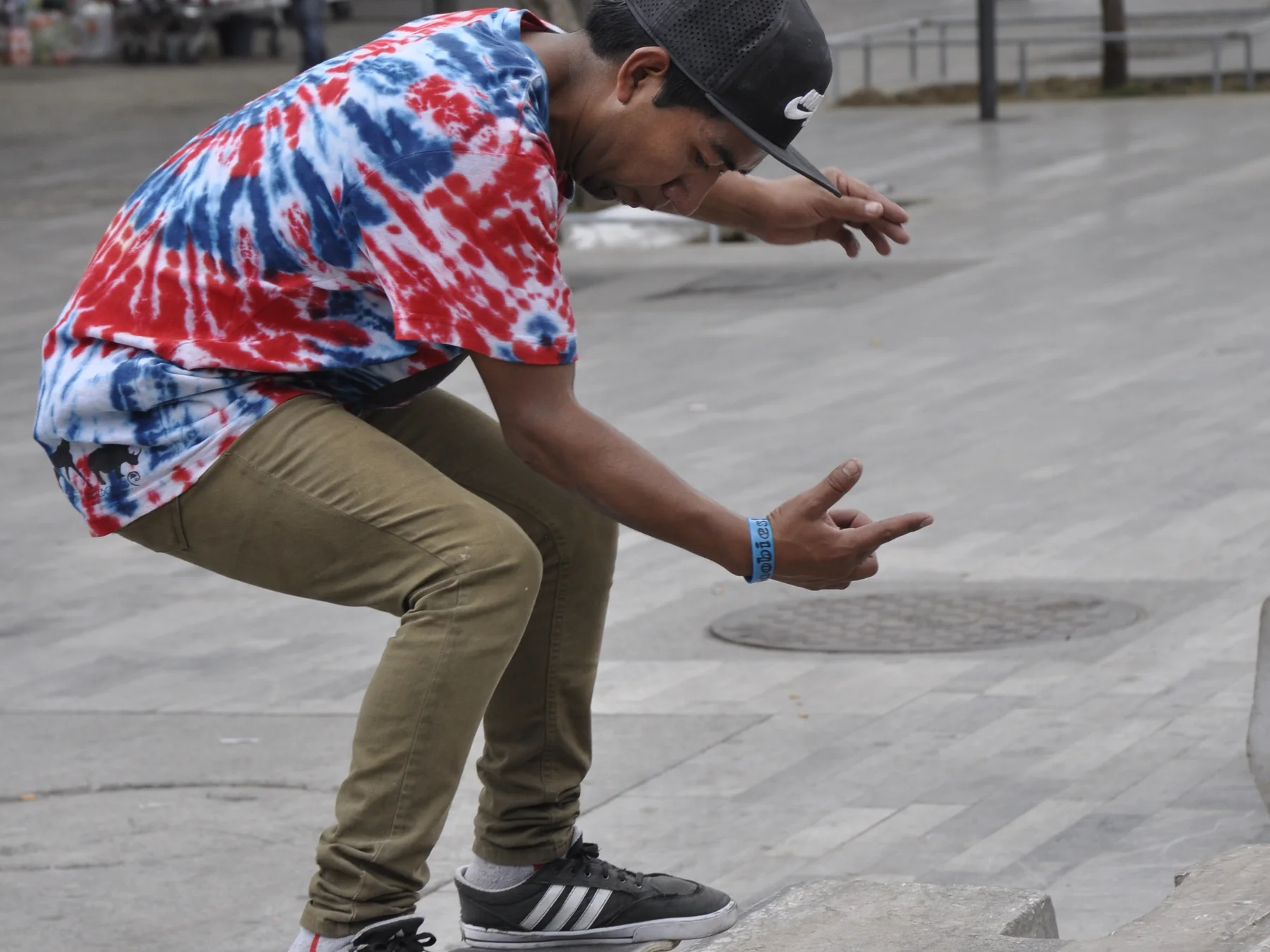 Skateboarder crouching while landing a street trick