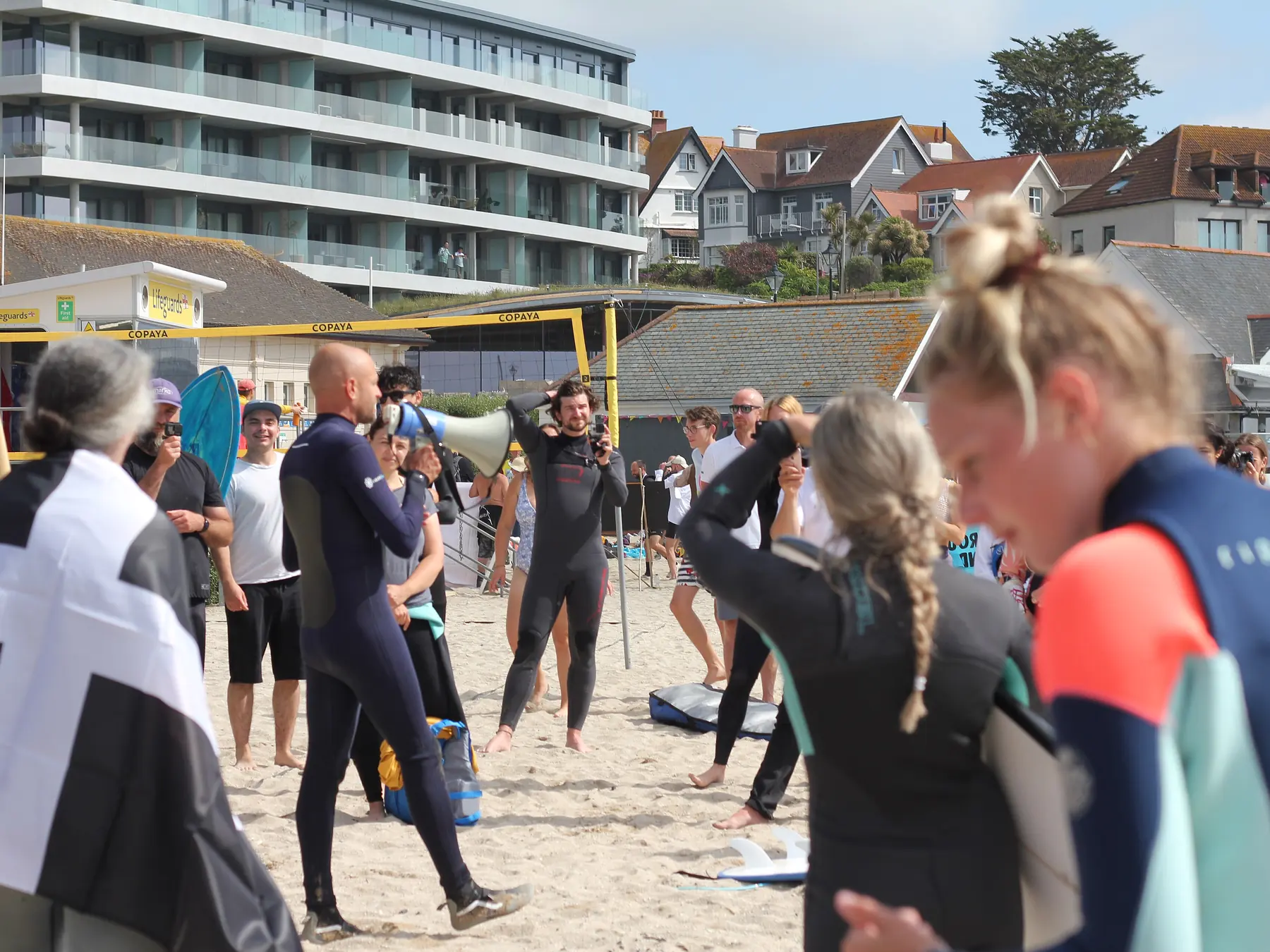 Group of surfers gathering for a lesson on the beach
