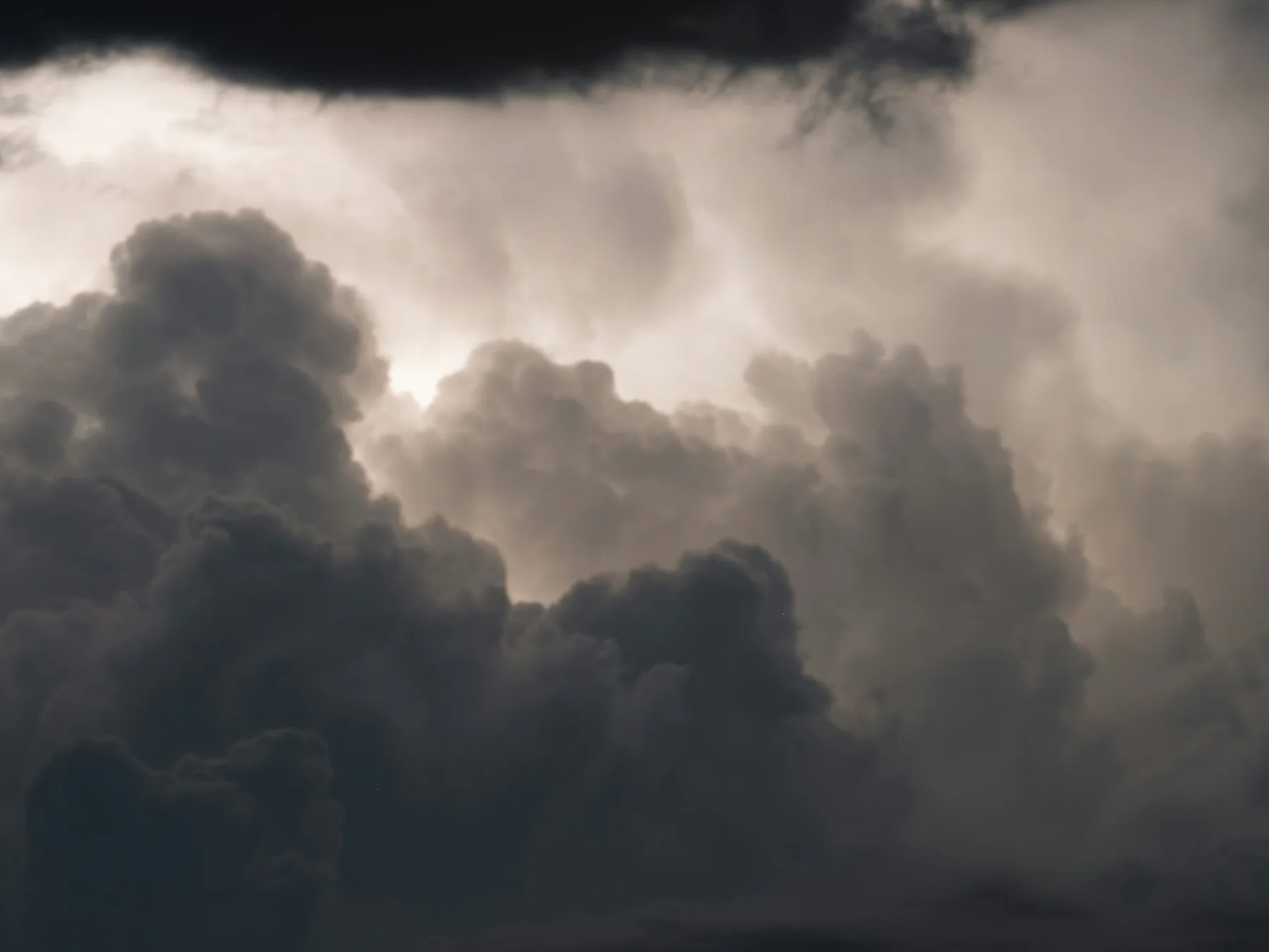 Thunderstorm clouds and lightning over a city skyline