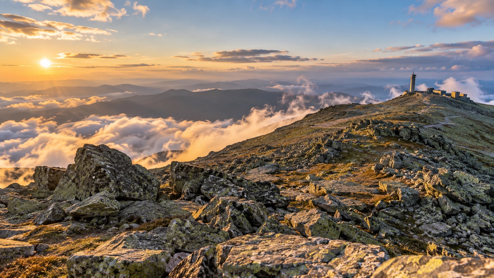 Mount Washington summit landscape with rugged rocky slopes and clouds