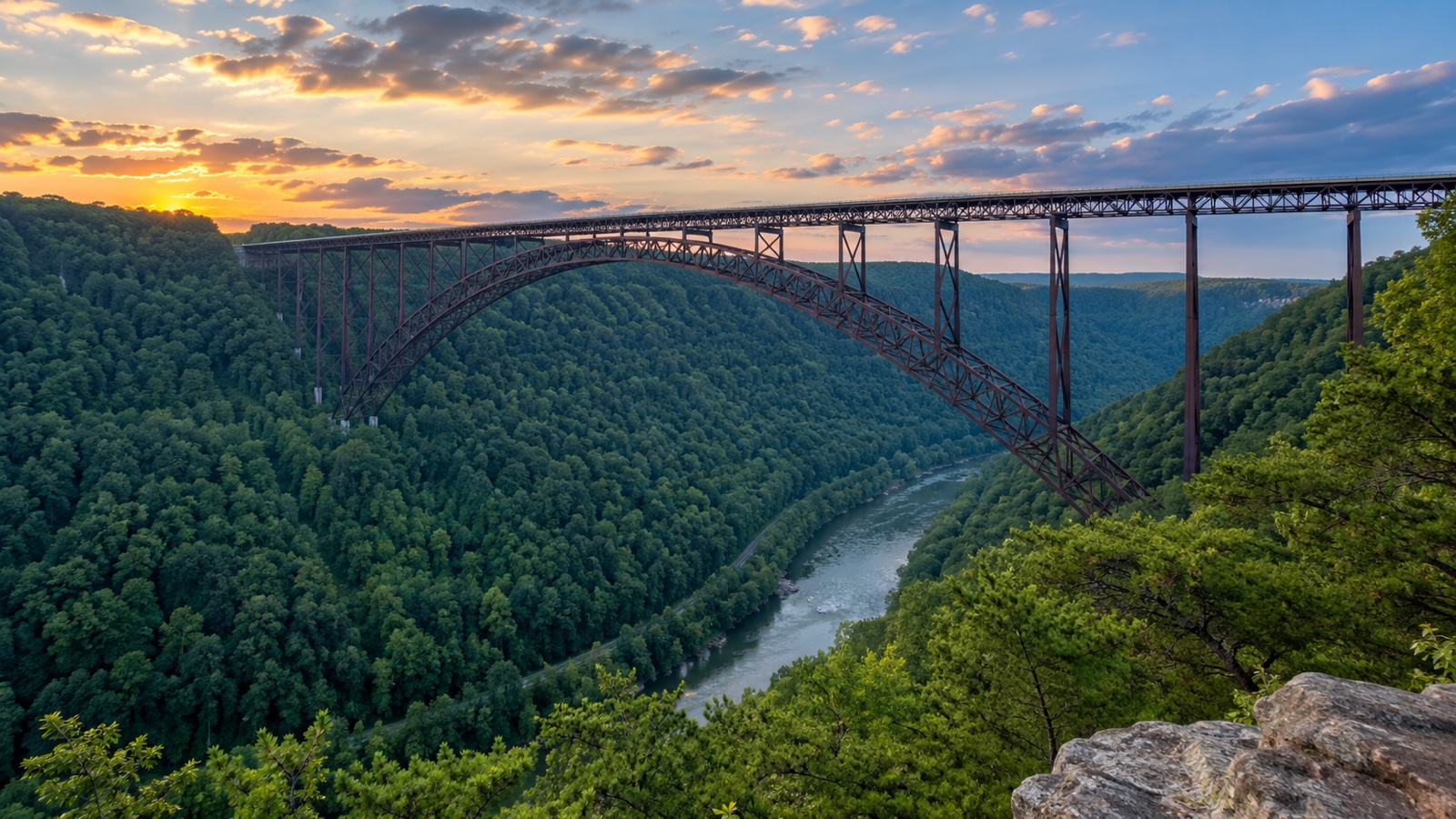 New River Gorge Bridge spanning a deep forested valley.