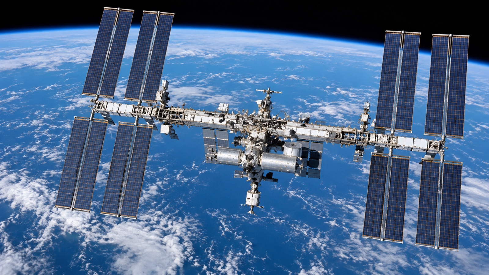Close external view of the station's expansive blue solar arrays.